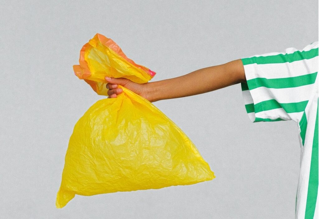hand holding a recycling bag